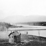 Looking west across False Creek from 7th Avenue and Birch Street - a house at 1304 West Seventh Avenue, the Granville Street Bridge, C.P.R. Kitsilano Trestle Bridge and Indian village of Snauq. (ca. 1890) 